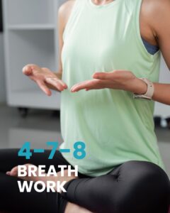 1. A woman in a calm, meditative pose is featured with the prominent text "4-7-8 BREATH WORK" overlaid on the image. She is seated cross-legged on a mat, with her hands open and resting on her knees, conveying a sense of serenity. The image effectively connects the practice of meditation with the specific 4-7-8 breathing technique, highlighting its use for achieving a state of calm.